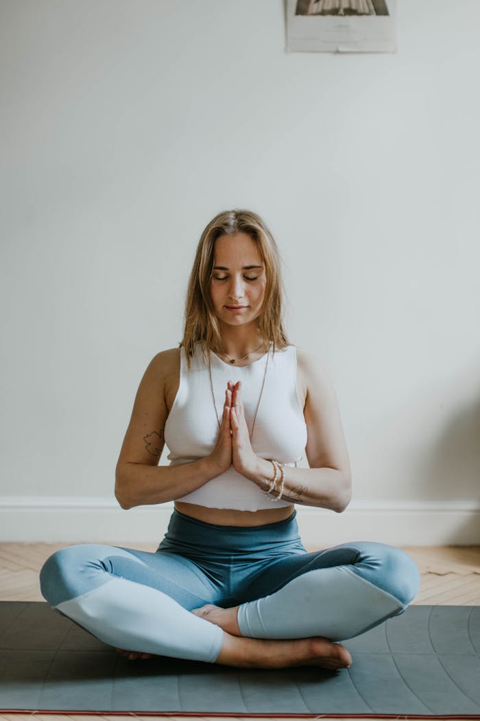 contact-img A serene image of a woman practicing meditation indoors, promoting mindfulness and wellbeing.